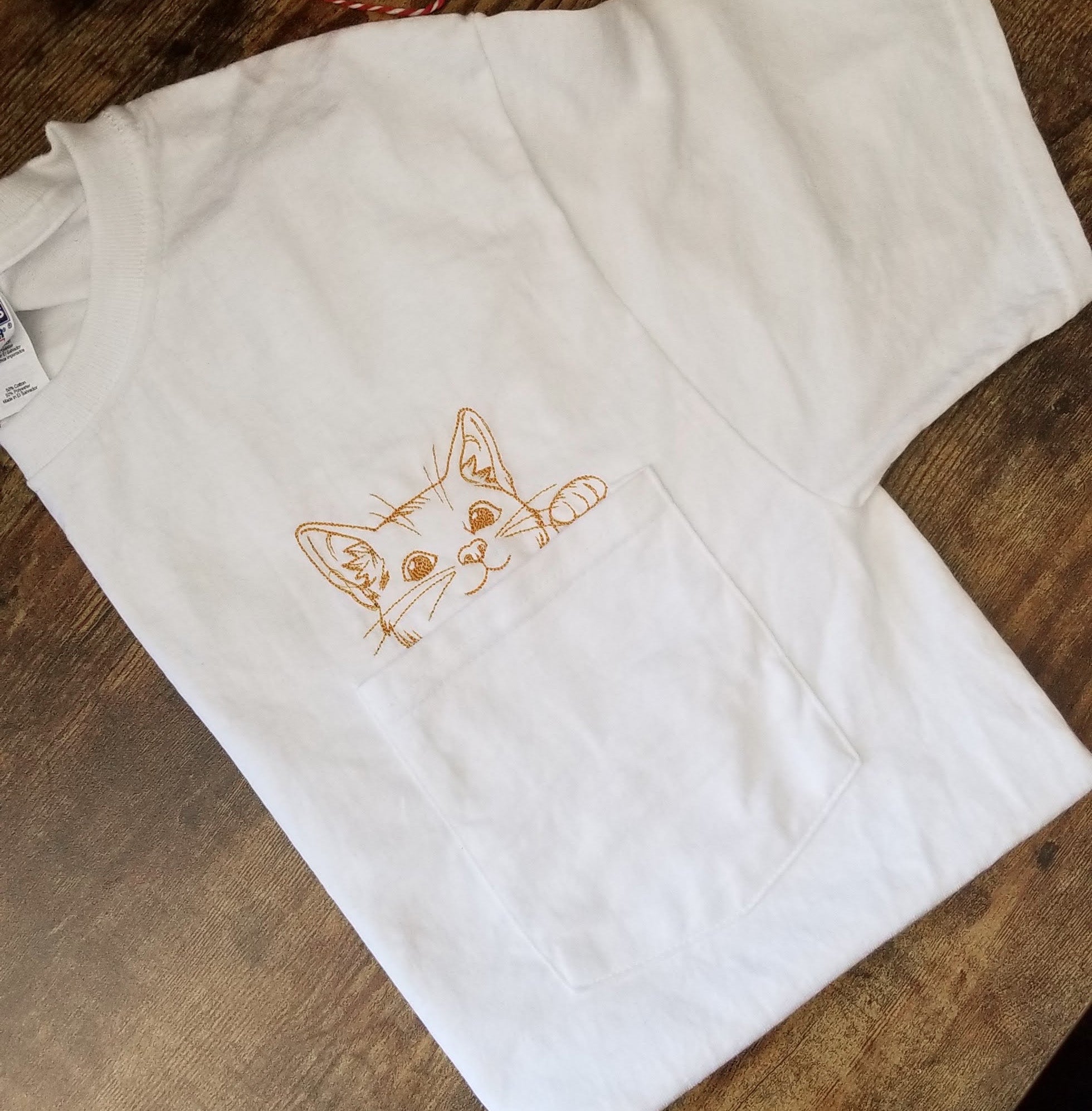 Cat coming out outlet of pocket shirt