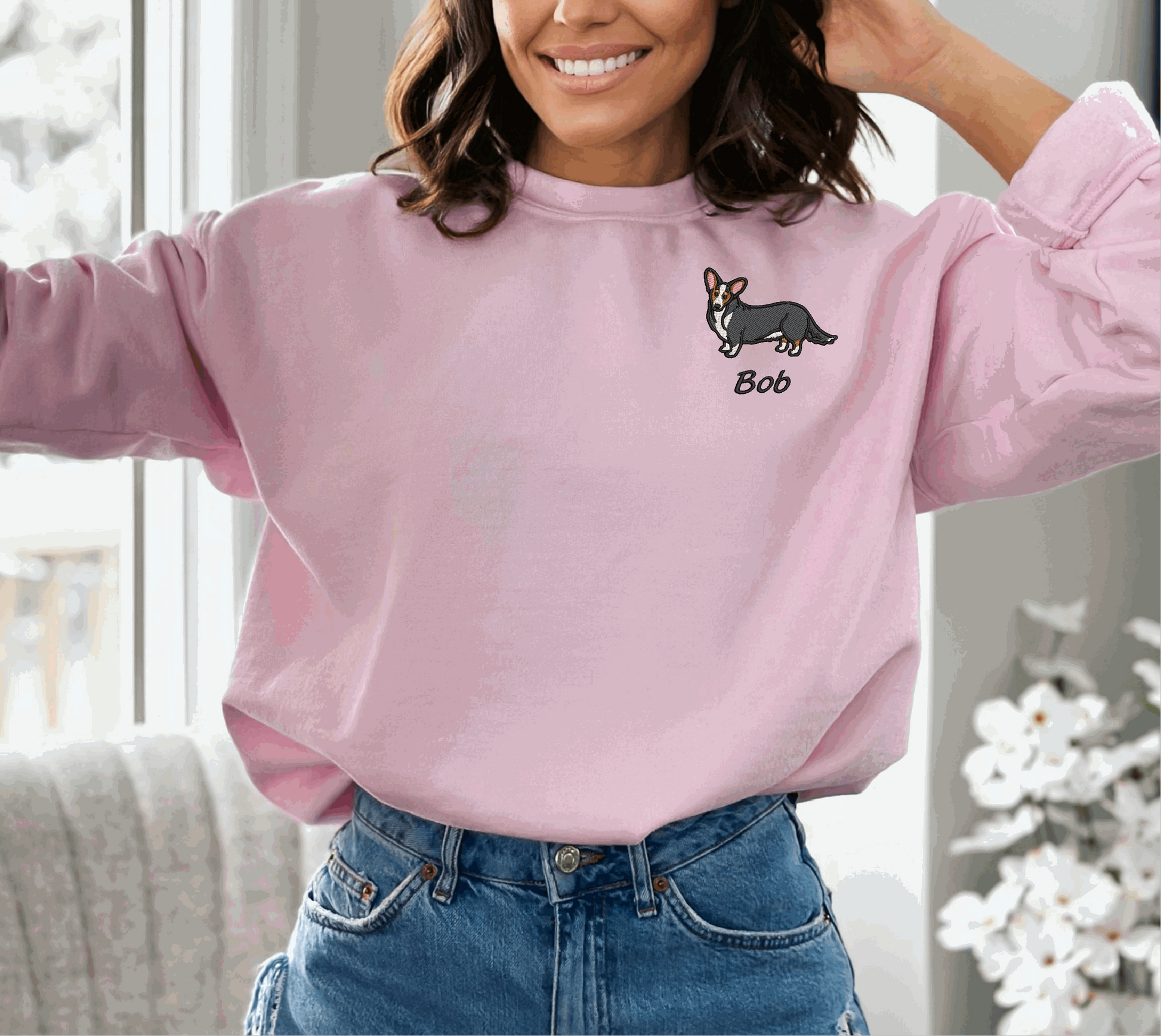a woman wearing a pink sweater with a dog on it