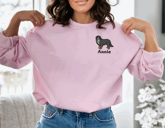 a woman wearing a pink sweater with an animal embroidered on it