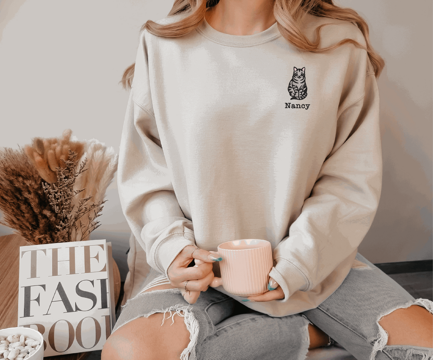 a woman sitting on a table holding a coffee cup